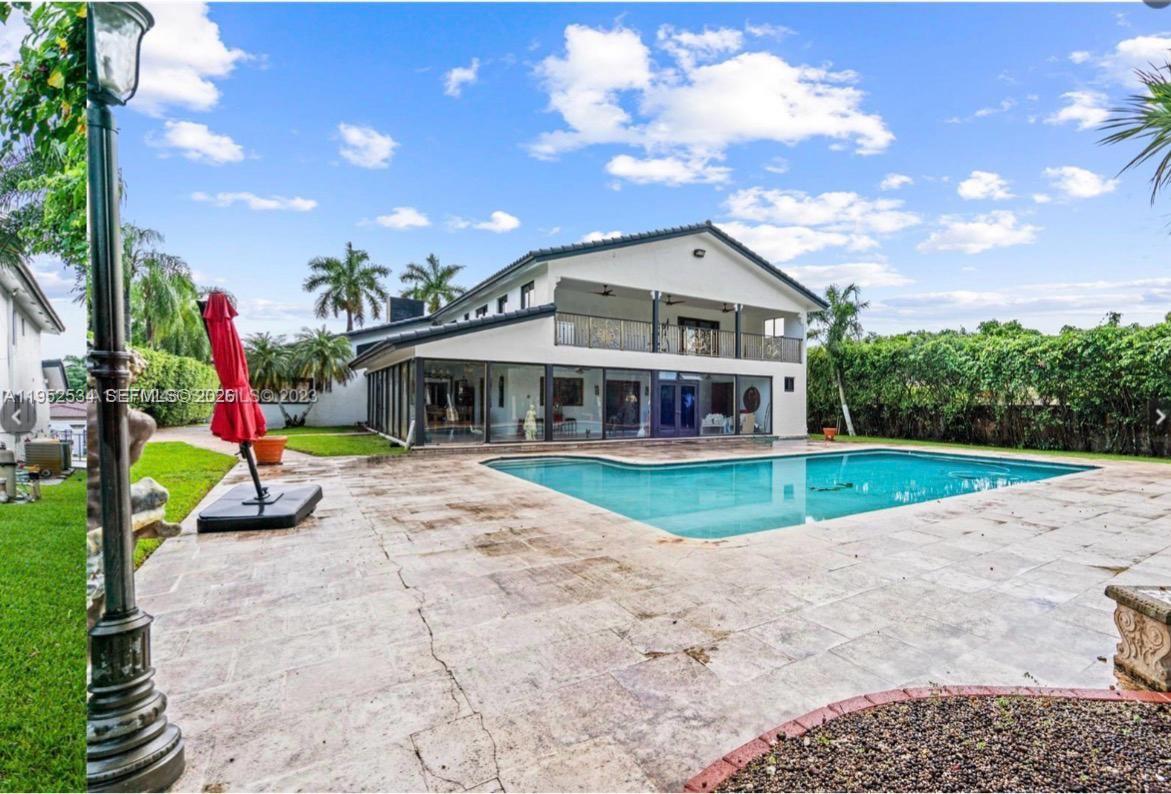 A two-story house with a large swimming pool and a stone patio in the backyard — 3420 SW 129th Ave, Miami FL 33175, MIAMI, FL