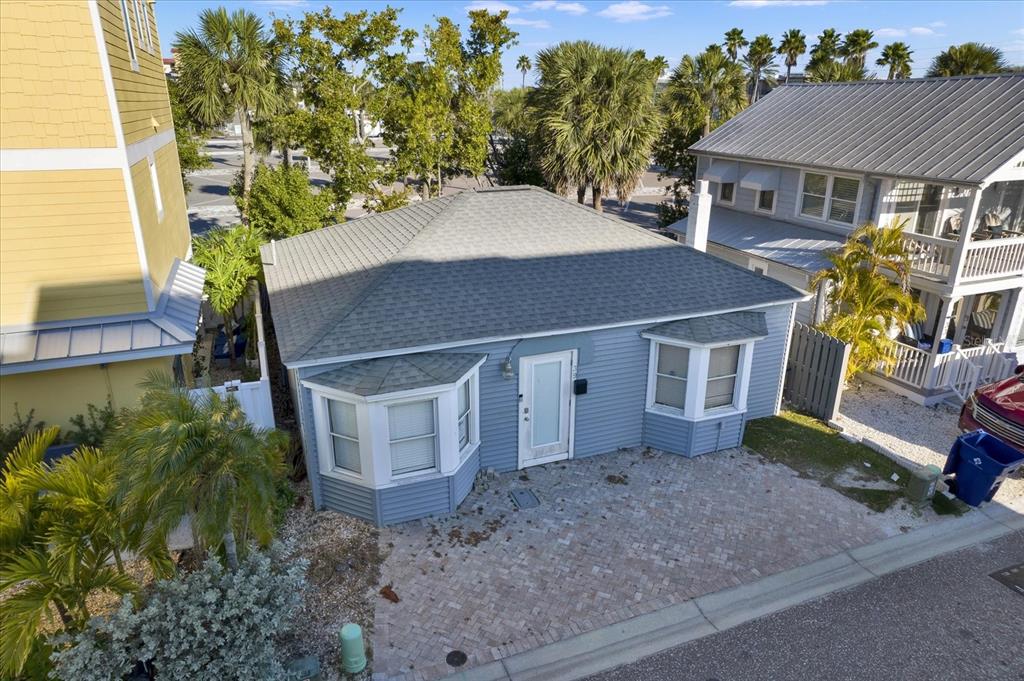 An aerial view of a light blue, single-story house with a gray shingled hip roof — 39 181ST AVENUE W, REDINGTON SHORES, FL