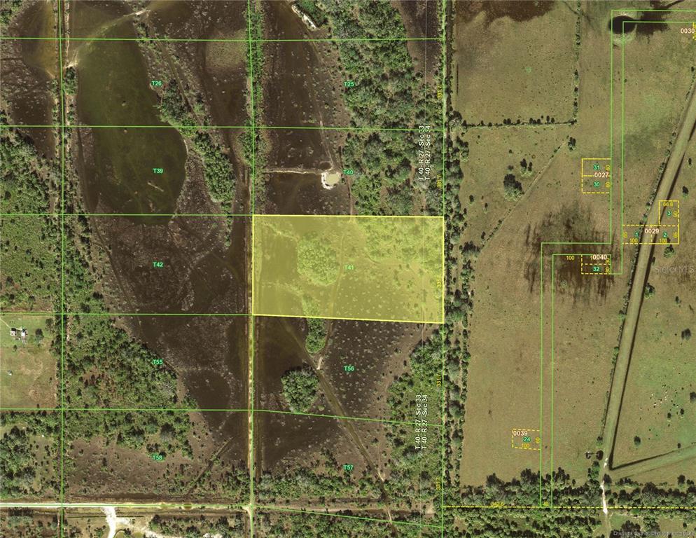 This is an aerial map showing a highlighted rectangular parcel of land surrounded by wetlands — 50964 BERMONT ROAD, PUNTA GORDA, FL