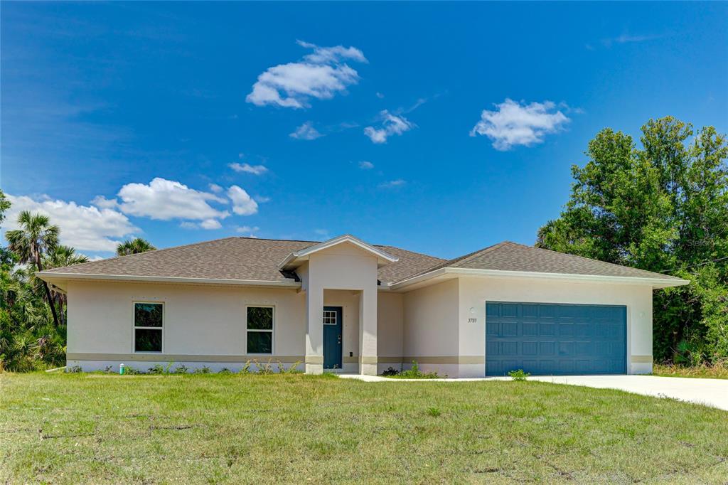A single-story house with a blue garage door and a covered entryway under a blue sky — 3789 URIAH STREET, NORTH PORT, FL