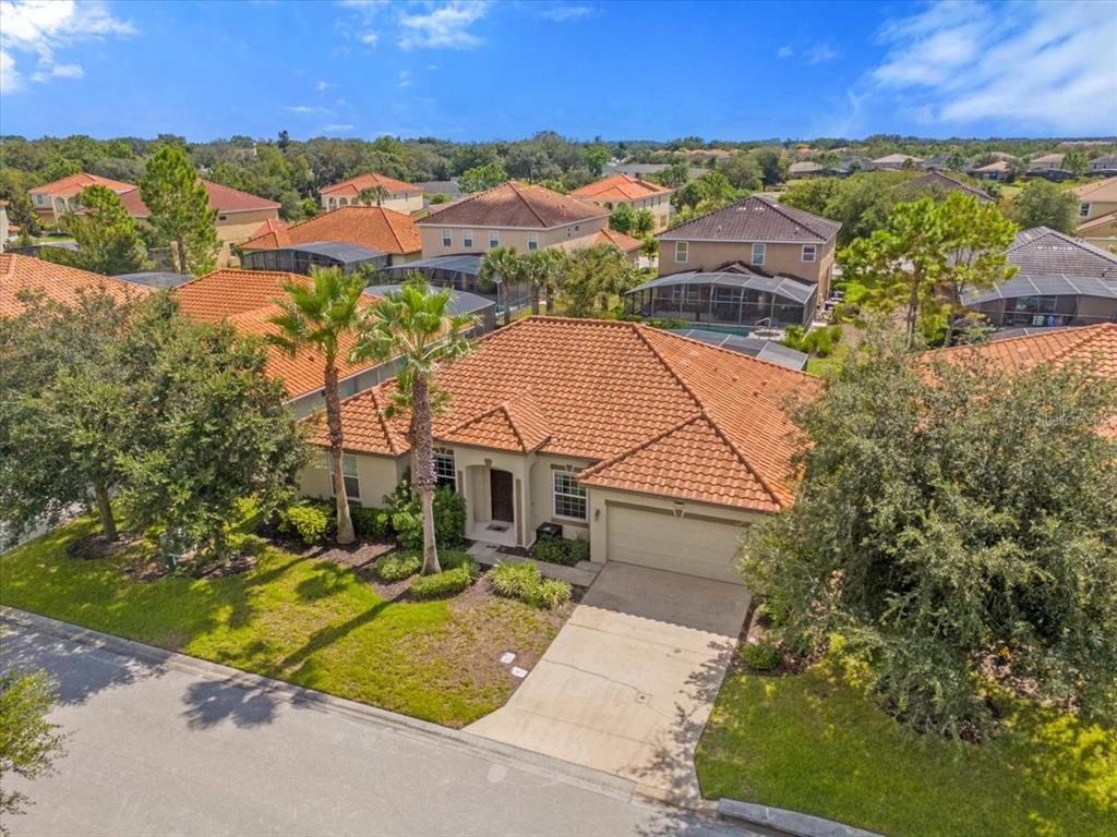 An aerial view of a single-story suburban house with a terracotta tile roof — 4072 OAKTREE DRIVE, DAVENPORT, FL