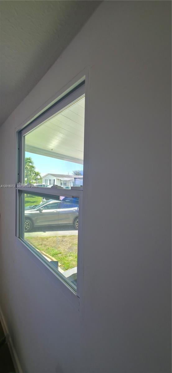 A view from inside a room looking out through a window at a parked car — 1730 SW 85th Ave, Davie FL 33324, DAVIE, FL
