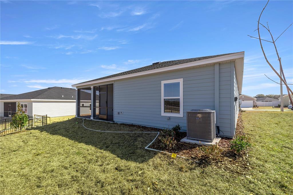 A blue-sided house with a screened-in porch and an outdoor air conditioning unit — 3254 NE 38TH LANE, OCALA, FL