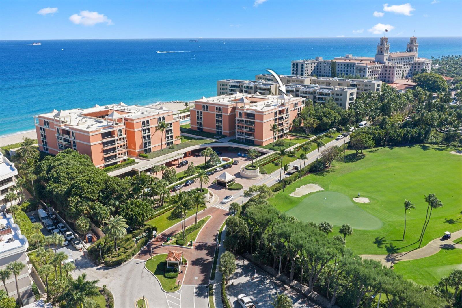 An aerial view shows peach-colored oceanfront condominiums next to a golf course and beach — 2 N Breakers Row # S32, Palm Beach FL 33480, PALM BEACH, FL