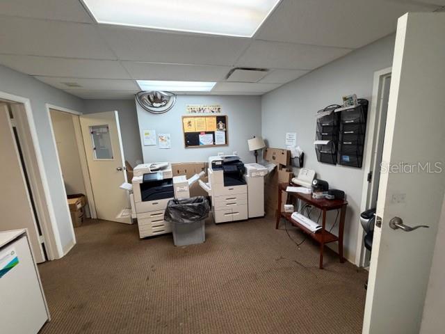 An office room features two large printers, a small side table, and wall-mounted document organizers — 663 HAROLD AVENUE, WINTER PARK, FL