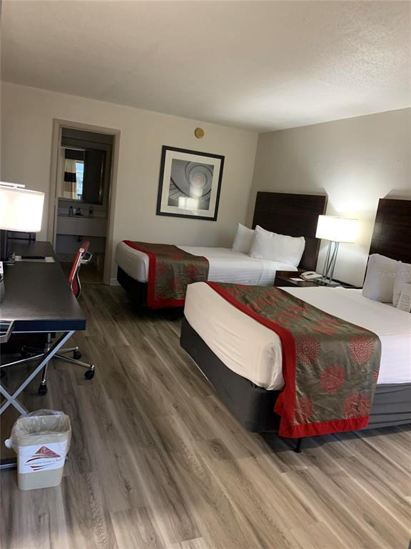 A hotel room features two beds, a desk, and wood-look flooring — 7150 N TAMIAMI TRAIL UNIT S-604, SARASOTA, FL