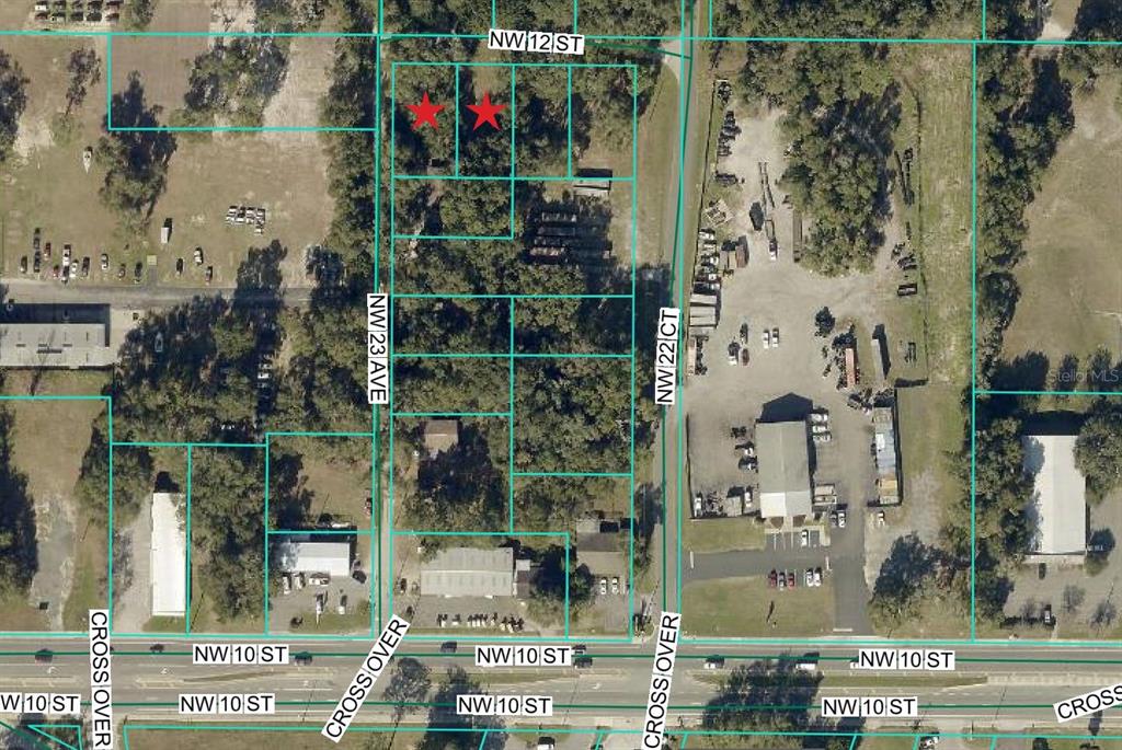 This is an aerial map showing several adjacent land parcels with two red stars — 2264 NW 12TH STREET, OCALA, FL