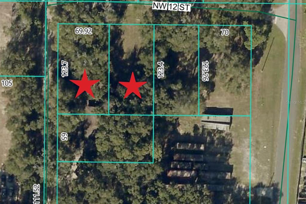 This is an aerial map showing two adjacent rectangular lots marked with red stars — 2264 NW 12TH STREET, OCALA, FL