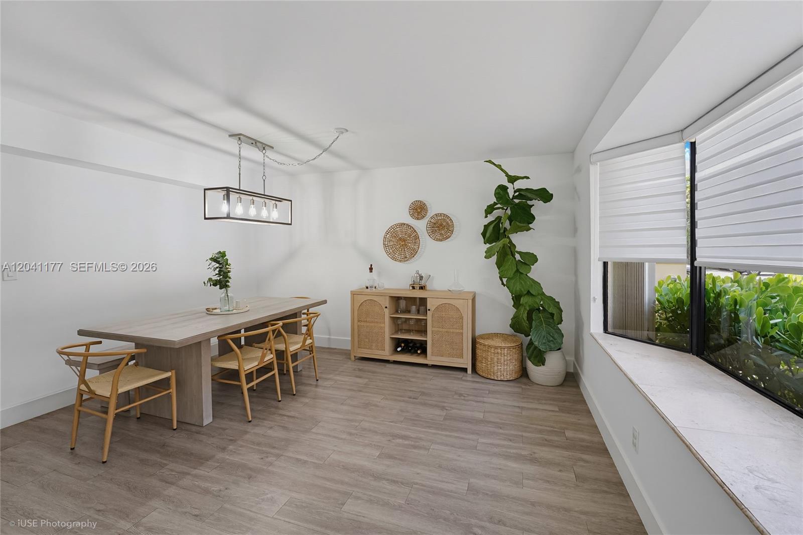 A dining room features a wooden table, chairs, a sideboard, and a large potted plant — 10137 SW 77th Ct, Miami FL 33156, MIAMI, FL