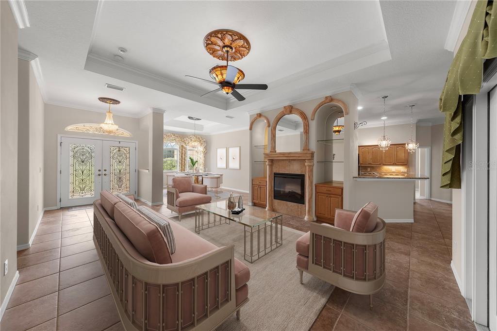 A living room features a fireplace, built-in shelving, tile flooring, and a tray ceiling — 5296 N PRINCEWOOD DRIVE, BEVERLY HILLS, FL