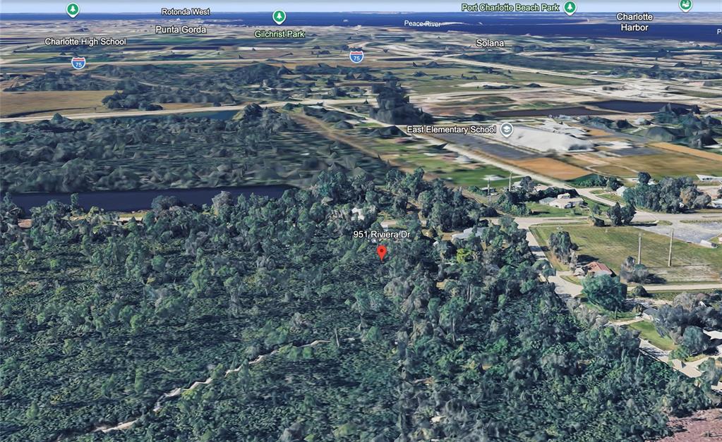 This is an aerial map view showing a wooded lot and surrounding neighborhood infrastructure — 951 RIVIERA DRIVE, PUNTA GORDA, FL