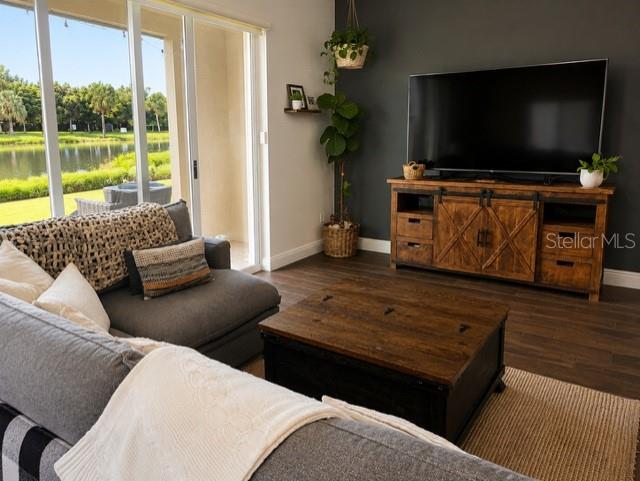 A living room features a gray sectional sofa, a wooden coffee table, and a television console — 1194 PAISLEY COURT, LAKE WORTH, FL