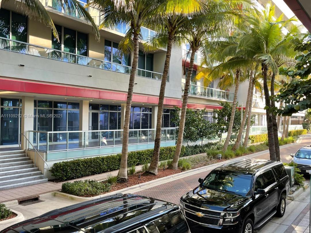 A multi-story building exterior features glass balconies, palm trees, and a black SUV parked below — 777 N Ocean Dr # N107, Hollywood FL 33019, HOLLYWOOD, FL