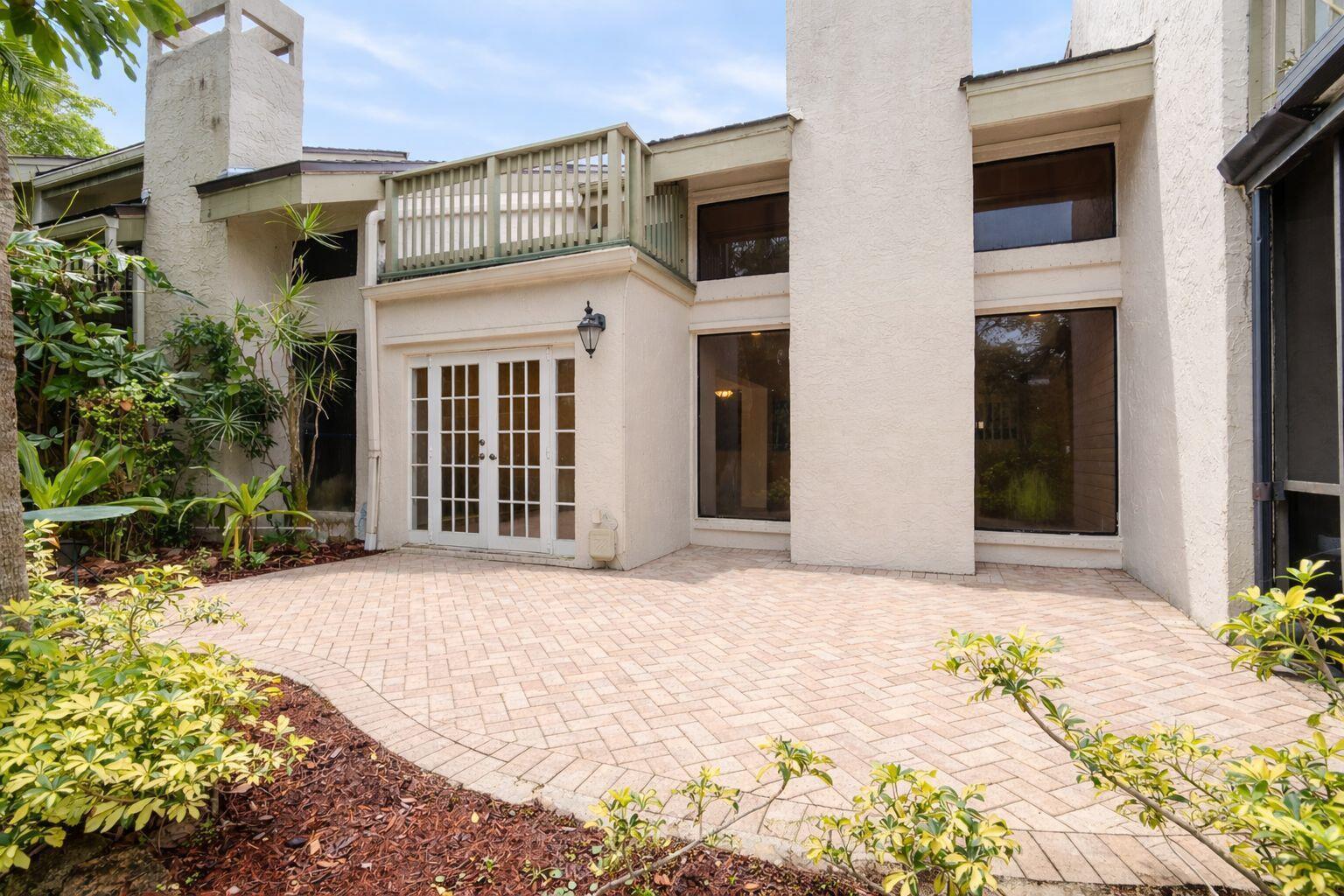 A walk-in shower with light tile walls, a mosaic floor, a bench, and glass doors — 22954 Ironwedge Drive, Boca Raton FL 33433, BOCA RATON, FL