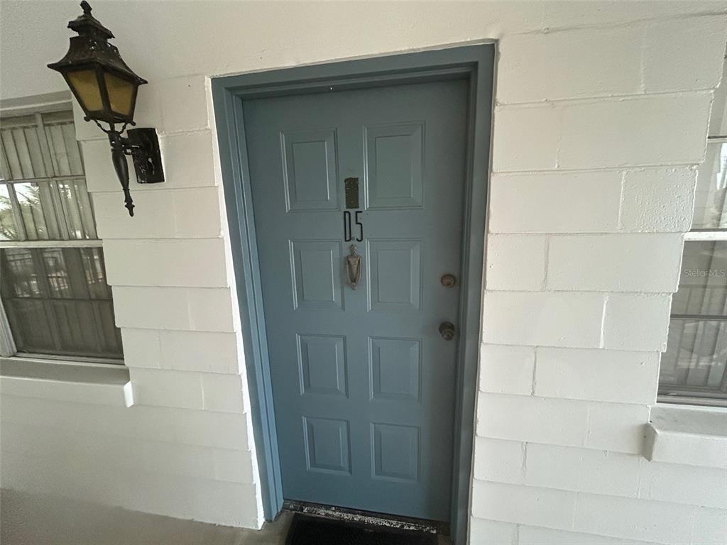A blue front door with the number 05 is set into a white painted brick wall — 2887 S OSCEOLA AVENUE UNIT D, ORLANDO, FL