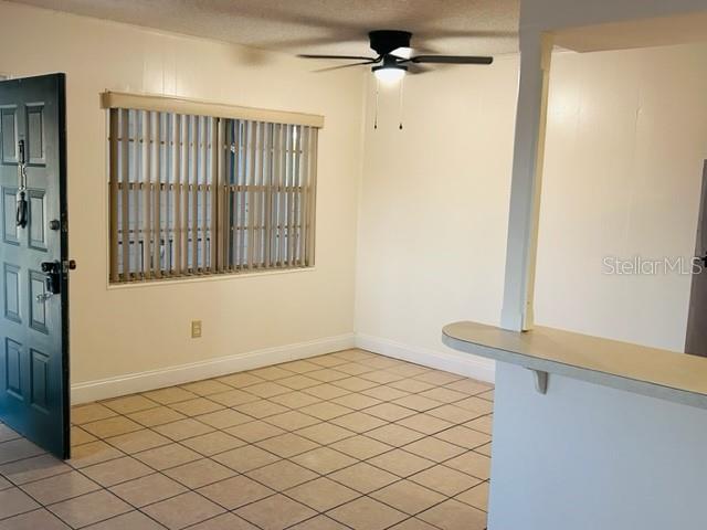 An interior view shows a room with tiled floors, a ceiling fan, and a window — 2887 S OSCEOLA AVENUE UNIT D, ORLANDO, FL