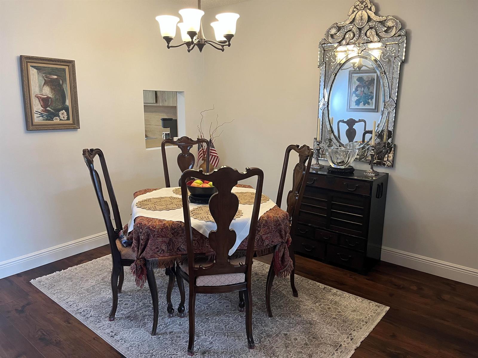 A dining room features a round table with four chairs, a mirror, and a chandelier — 2638 Gately Drive E # 112, West Palm Beach FL 33415, WEST PALM BEACH, FL