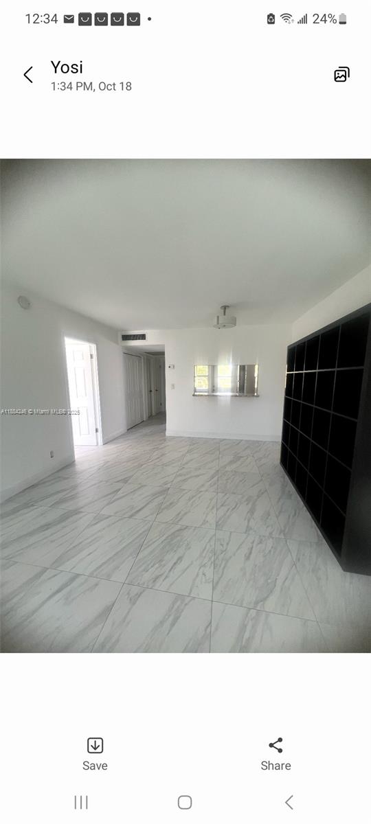 A room with white marble-patterned tile flooring and a large black shelving unit — 2300 Park Ln # 211, Hollywood FL 33021, HOLLYWOOD, FL