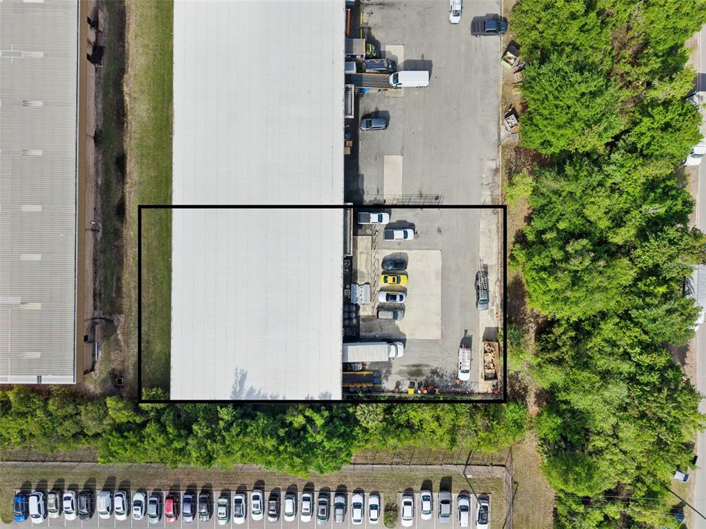 An aerial view shows a commercial building with a loading dock and parking lot — 10235 GENERAL DRIVE UNIT 8, ORLANDO, FL