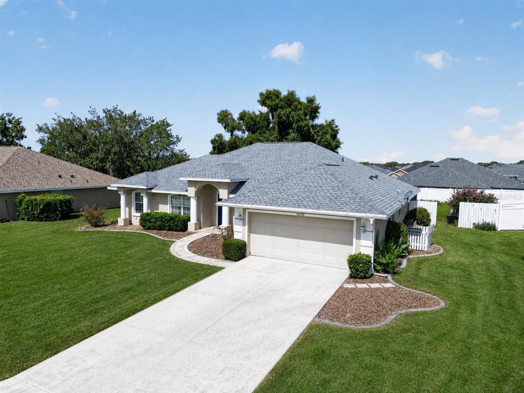 An aerial view of a single-story house with a gray roof and a concrete driveway — 8328 SW 56TH TERRACE, OCALA, FL