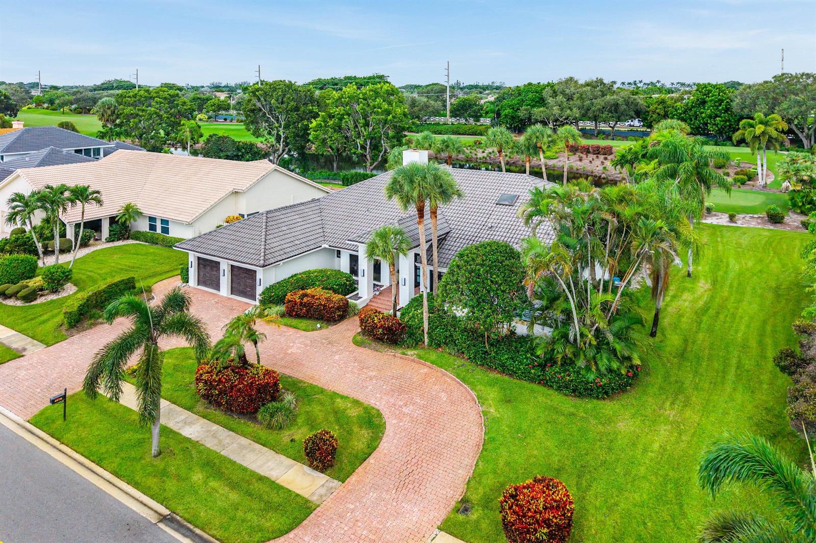 An aerial view of a single-story house with a brick driveway and a tile roof — 4976 Bocaire Boulevard, Boca Raton FL 33487, BOCA RATON, FL