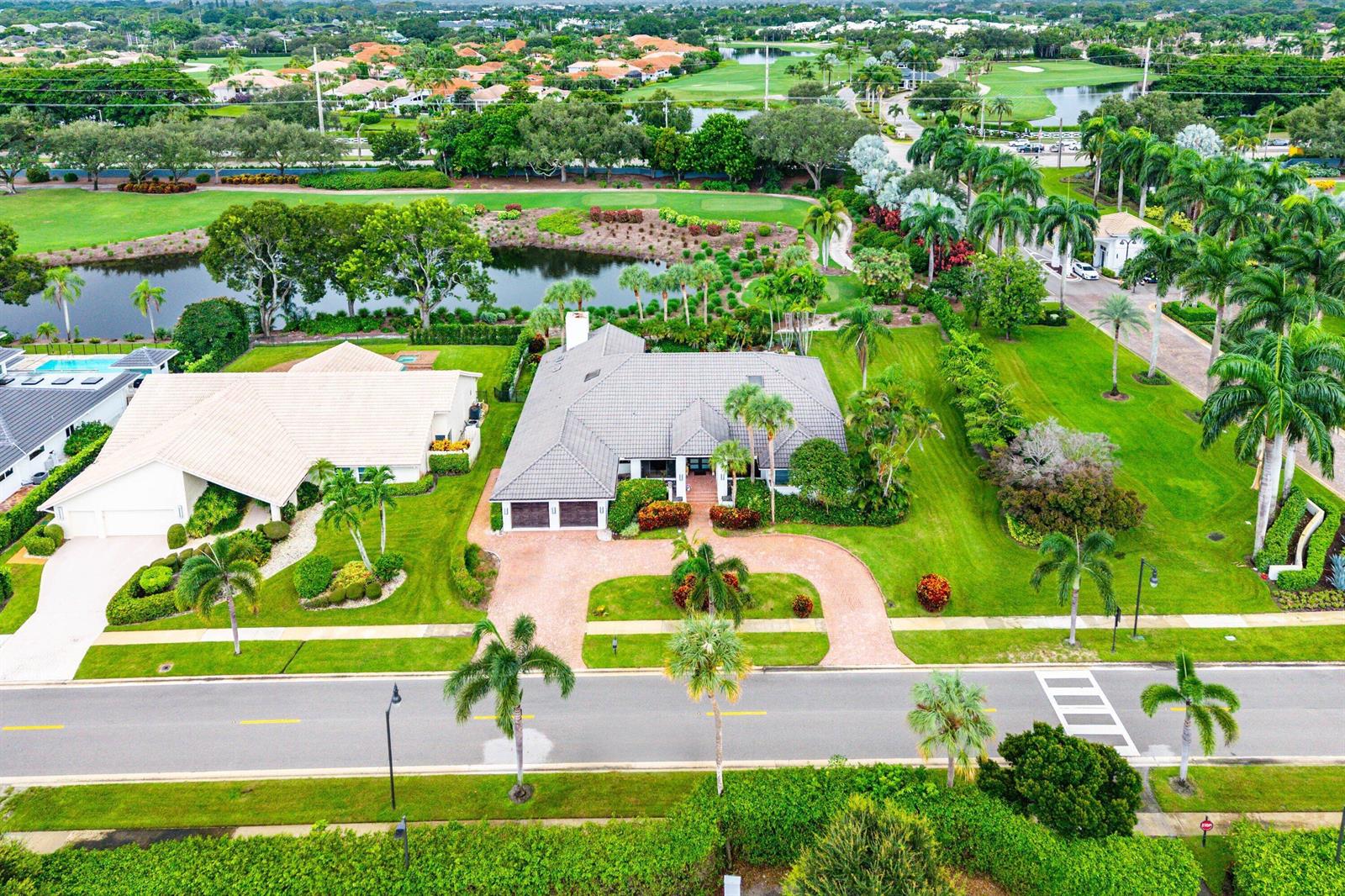 An aerial view shows a single-story house with a tiled roof, circular driveway, and pool — 4976 Bocaire Boulevard, Boca Raton FL 33487, BOCA RATON, FL