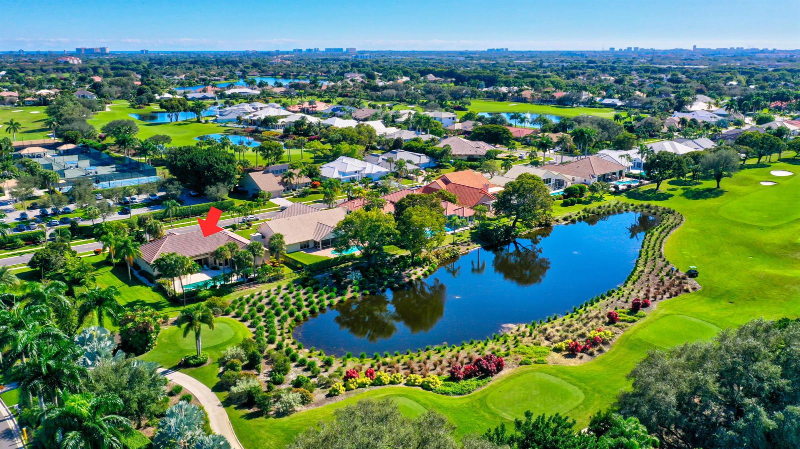 An aerial view of a house with a pool overlooking a pond and golf course — 4976 Bocaire Boulevard, Boca Raton FL 33487, BOCA RATON, FL