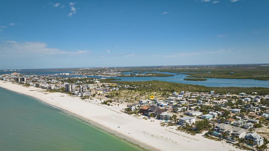 An aerial view shows a coastal beach town with a yellow star marking a building — 3045 ESTERO BOULEVARD UNIT 6A, FORT MYERS BEACH, FL
