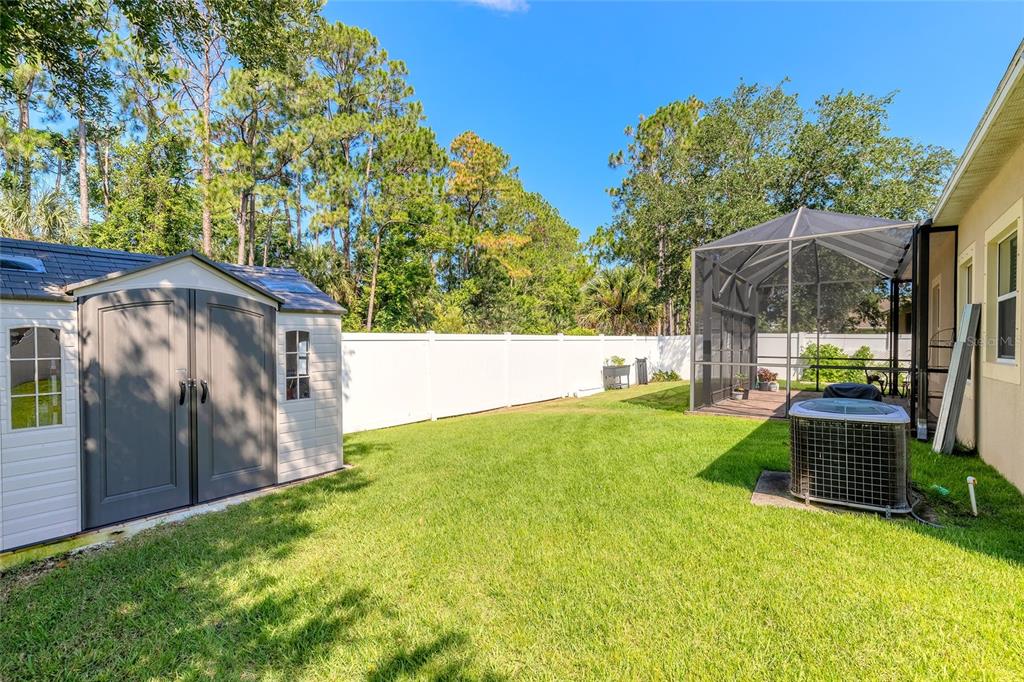 A backyard features a storage shed, a screened-in patio, and an air conditioning unit — 3968 SUNSET COVE DRIVE, PORT ORANGE, FL