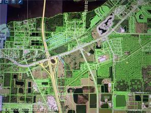 This is an aerial map showing land parcels outlined in green near a highway interchange — 811 Yellowtail Lane, Punta Gorda FL 33982, PUNTA GORDA, FL