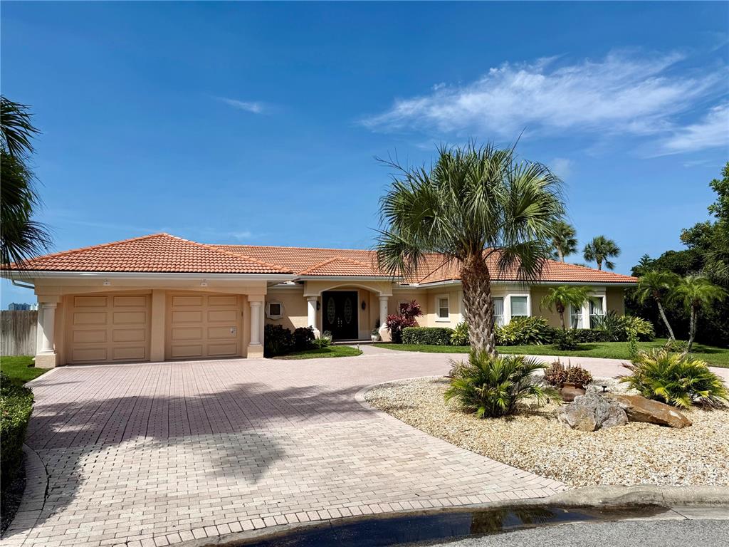 A single-story house with a tiled roof, two-car garage, and a paved driveway — 376 W ROYAL FLAMINGO DRIVE, SARASOTA, FL
