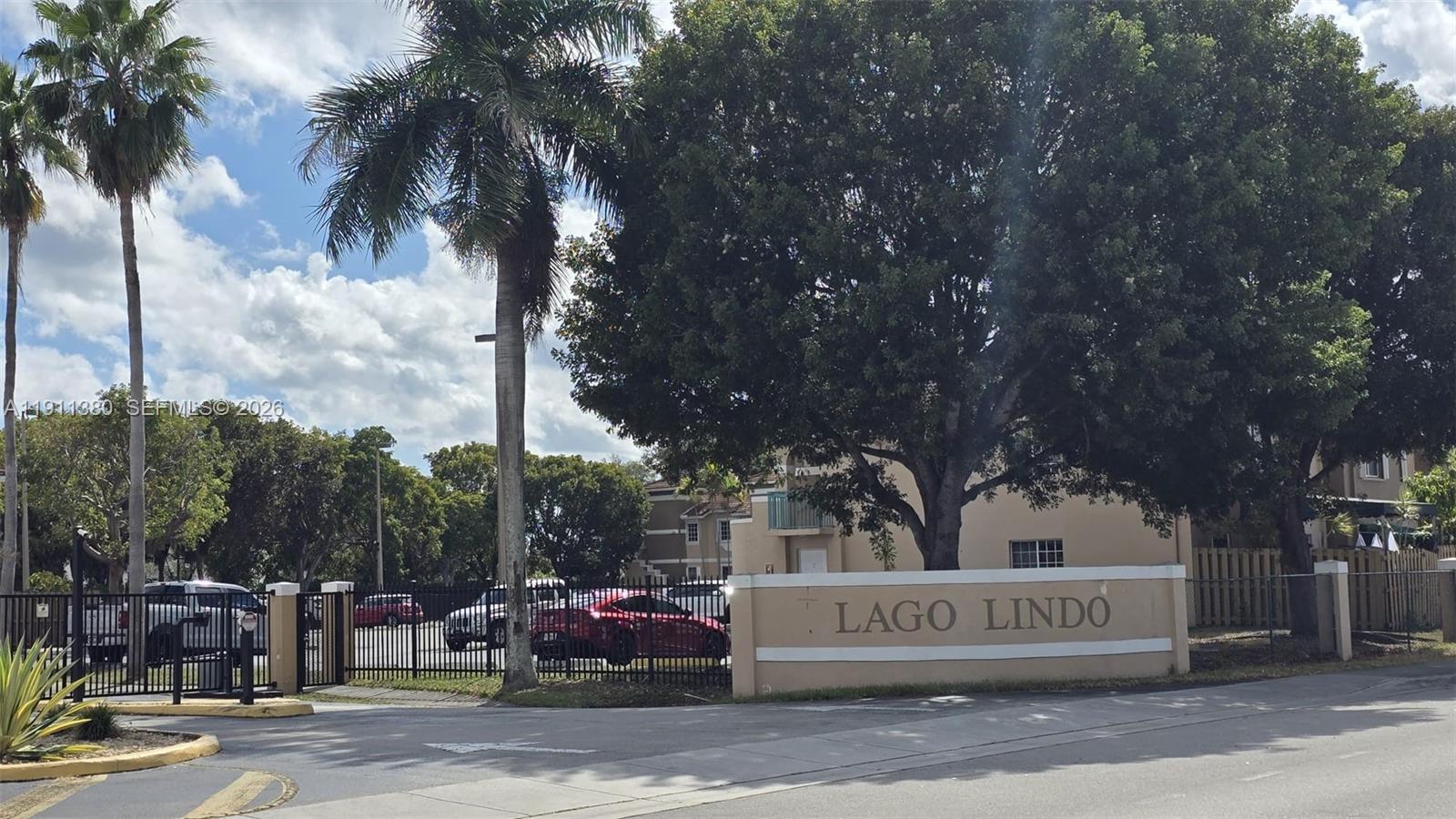 The entrance to the Lago Lindo residential community features a gated driveway and signage — 13120 SW 64th Ter # 1510, Miami FL 33183, MIAMI, FL