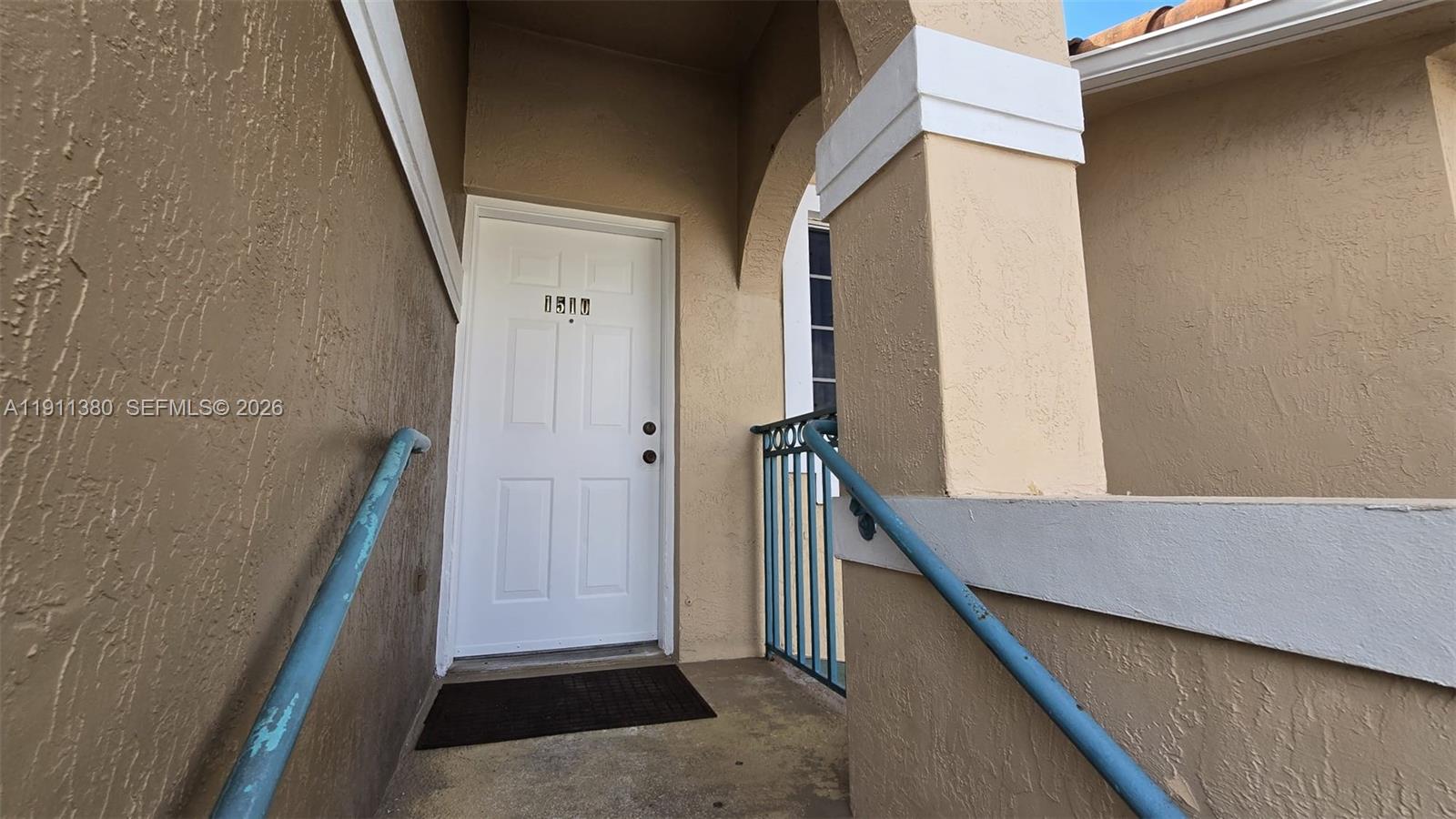 A white front door with the number 1510 is accessed by a concrete entryway — 13120 SW 64th Ter # 1510, Miami FL 33183, MIAMI, FL