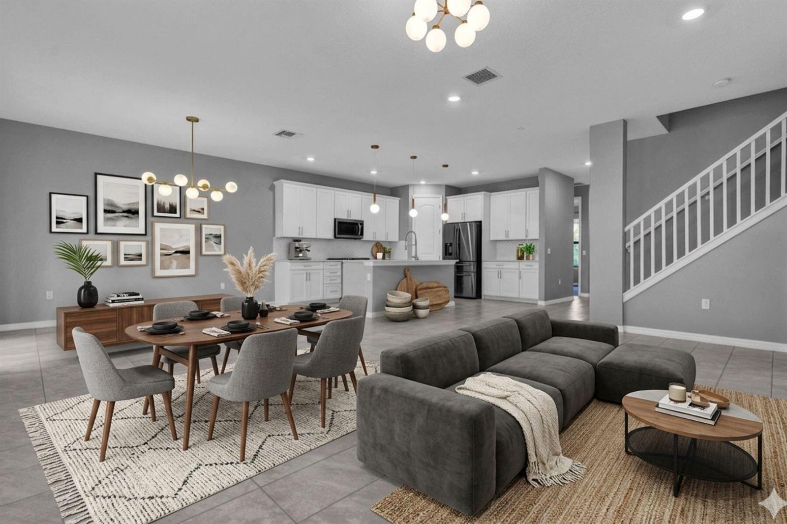An open-concept living and dining area features gray walls, white cabinetry, and a gray sectional — 8296 Vaulting Drive, Lake Worth FL 33467, LAKE WORTH, FL