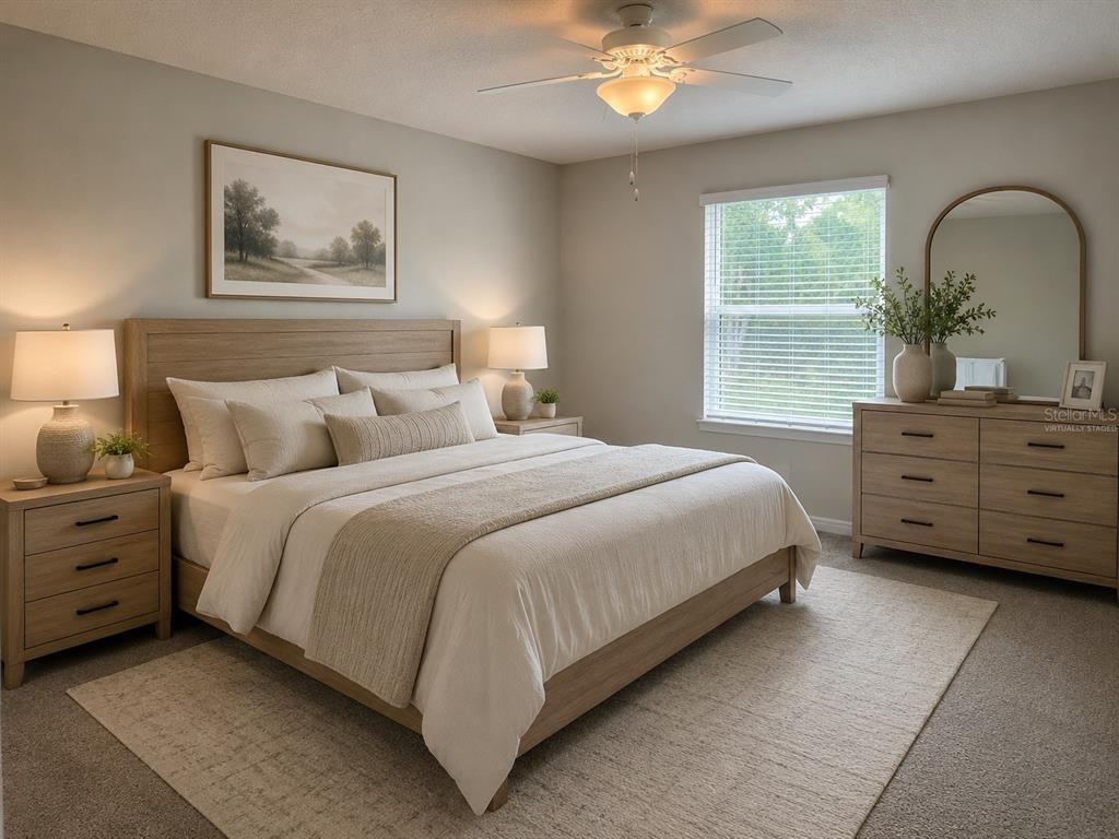 A bedroom features a light wood bed frame, matching nightstands, a dresser, and a ceiling fan — 2966 DEER PINE TRAIL, LAND O LAKES, FL