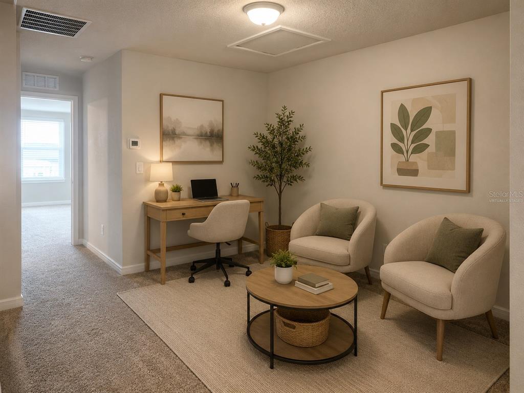 A home office features a desk, two armchairs, a coffee table, and a potted plant — 2966 DEER PINE TRAIL, LAND O LAKES, FL