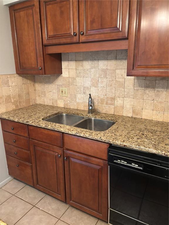A kitchen features wood cabinets, granite countertops, a stainless steel sink, and tiled backsplash — 6645 1ST AVENUE N UNIT 307, ST PETERSBURG, FL