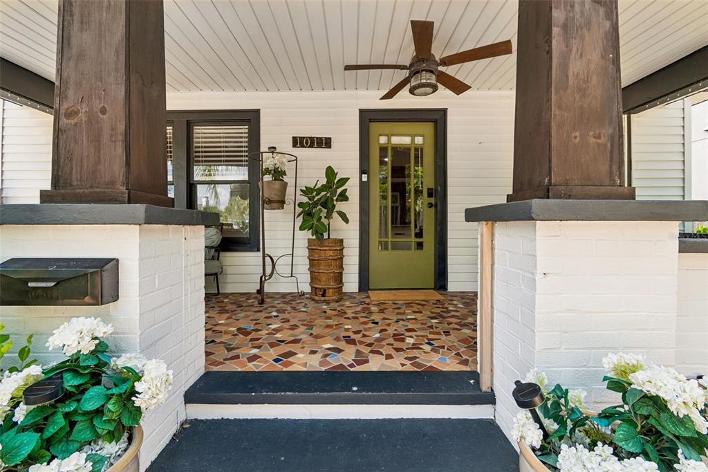 A backyard patio with a pergola, outdoor seating, and a house at sunset — 1011 14TH STREET N, ST PETERSBURG, FL