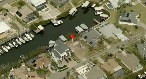 This aerial view shows a vacant waterfront lot with a red marker pin — 6508 BLACKFIN WAY, APOLLO BEACH, FL