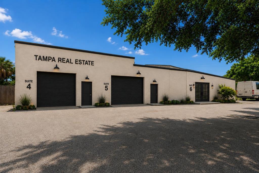 Exterior view of a single-story commercial building with three suites and a gravel parking lot — 4214 W VIRGINIA AVE UNIT 12, TAMPA, FL