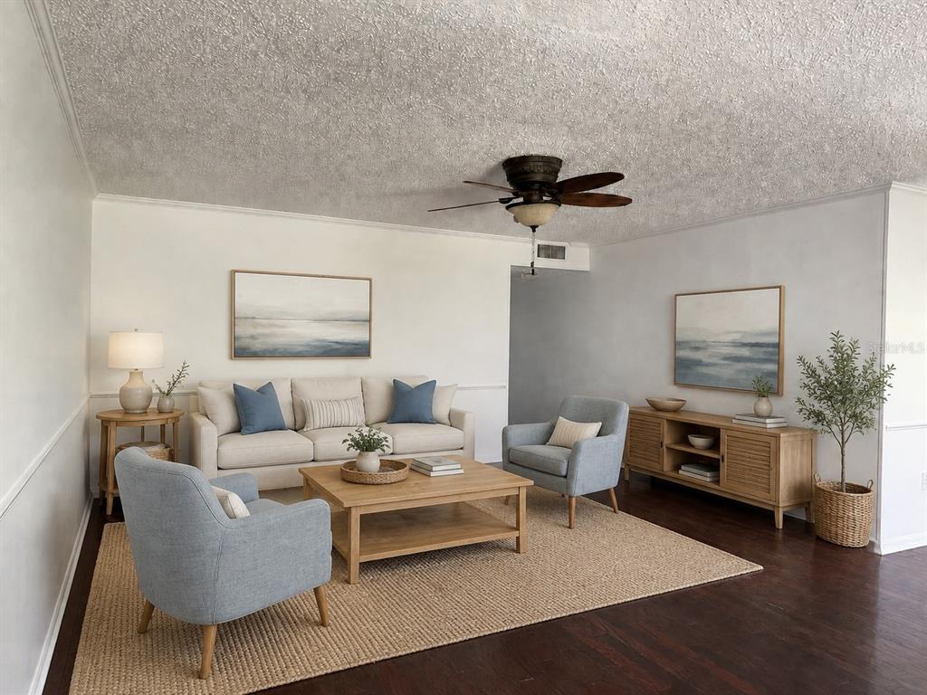 A living room features a beige sofa, two light blue armchairs, and a wooden coffee table — 350 79TH AVE N UNIT 102, ST PETERSBURG, FL