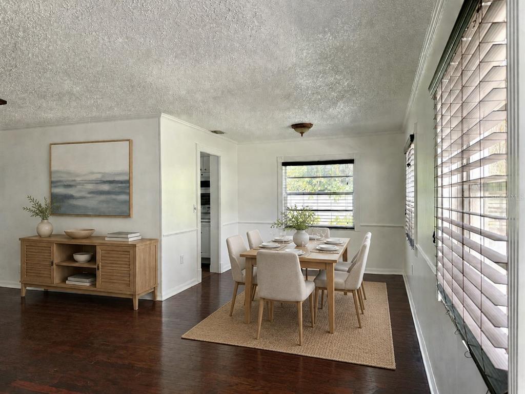 A dining room features a wooden table with six chairs, a sideboard, and hardwood floors — 350 79TH AVE N UNIT 102, ST PETERSBURG, FL