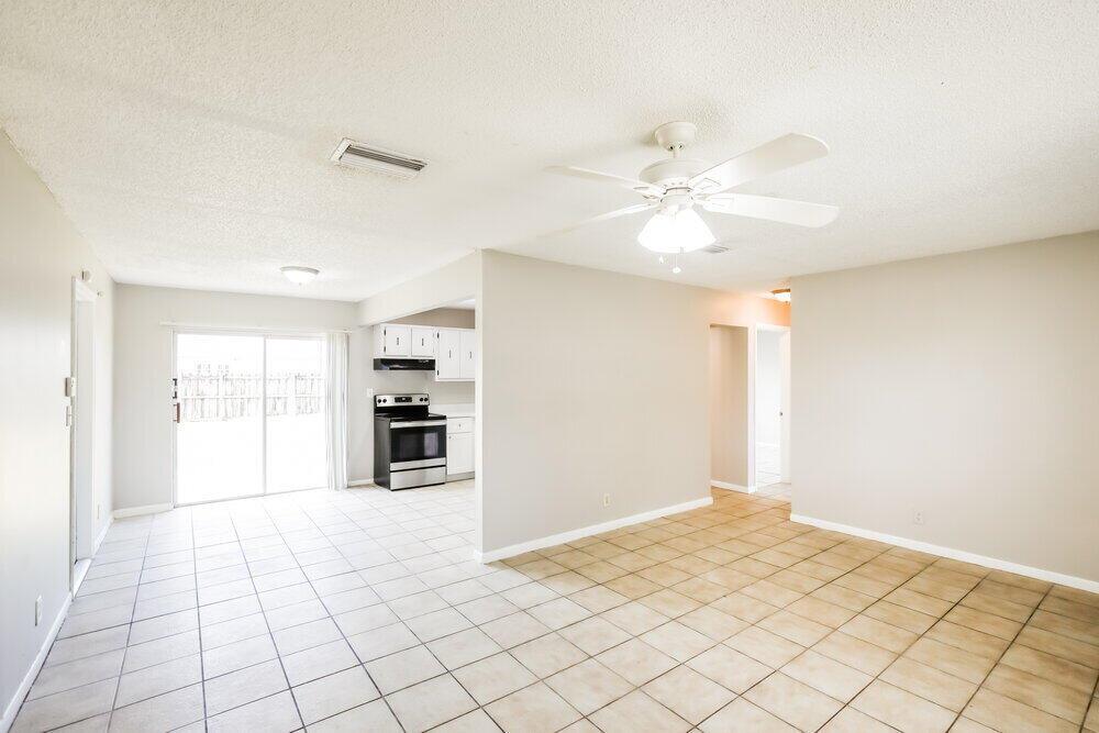 An open-concept living and dining area features light-colored tile flooring and a ceiling fan — NORTH LAUDERDALE, FL