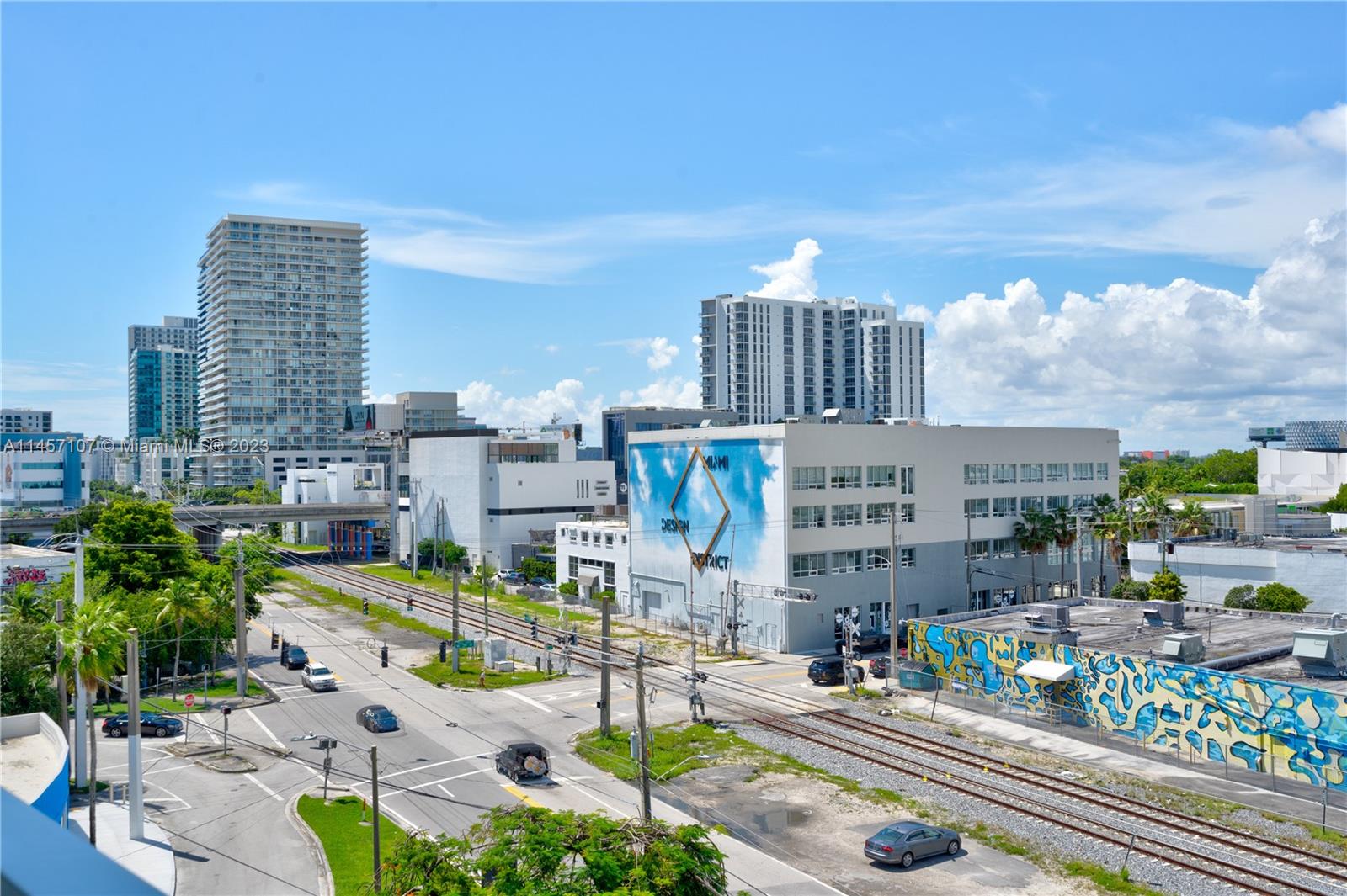 An elevated view of a city street intersection with railroad tracks and surrounding buildings — 3900 Biscayne Blvd # 502, Miami FL 33137, MIAMI, FL
