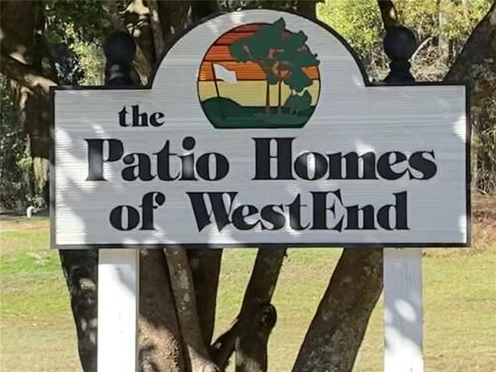 A sign for The Patio Homes of WestEnd stands outdoors in front of trees — 12345 NW 10TH PLACE, NEWBERRY, FL