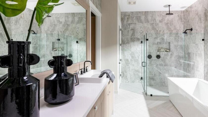 A modern bathroom features a white vanity, a glass-enclosed shower, and a freestanding bathtub — 9854 Regency Way, Palm Beach Gardens FL 33412, PALM BEACH GARDENS, FL