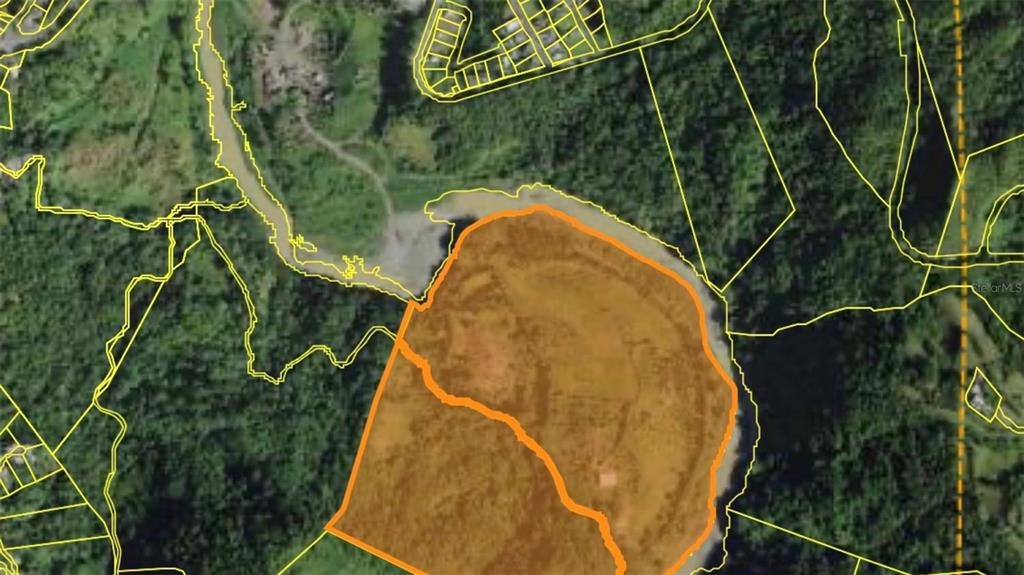 An aerial map view shows a large, orange-outlined parcel of land surrounded by dense forest — KM 14.5 KM 14.5, CIALES, PR