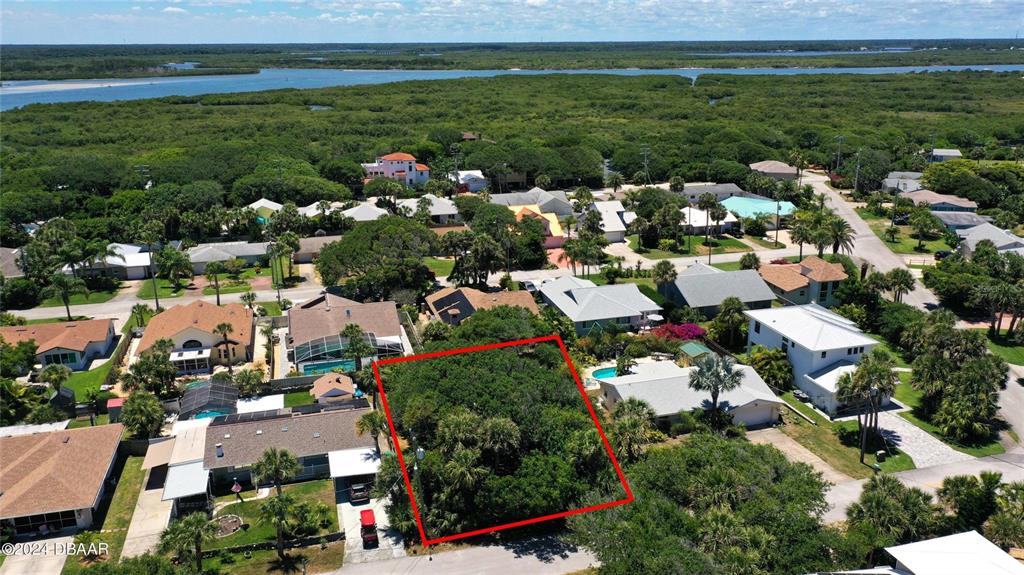 An aerial view shows a coastal neighborhood with houses, trees, and a beach access path — 4714 MONTROSE AVENUE, PONCE INLET, FL