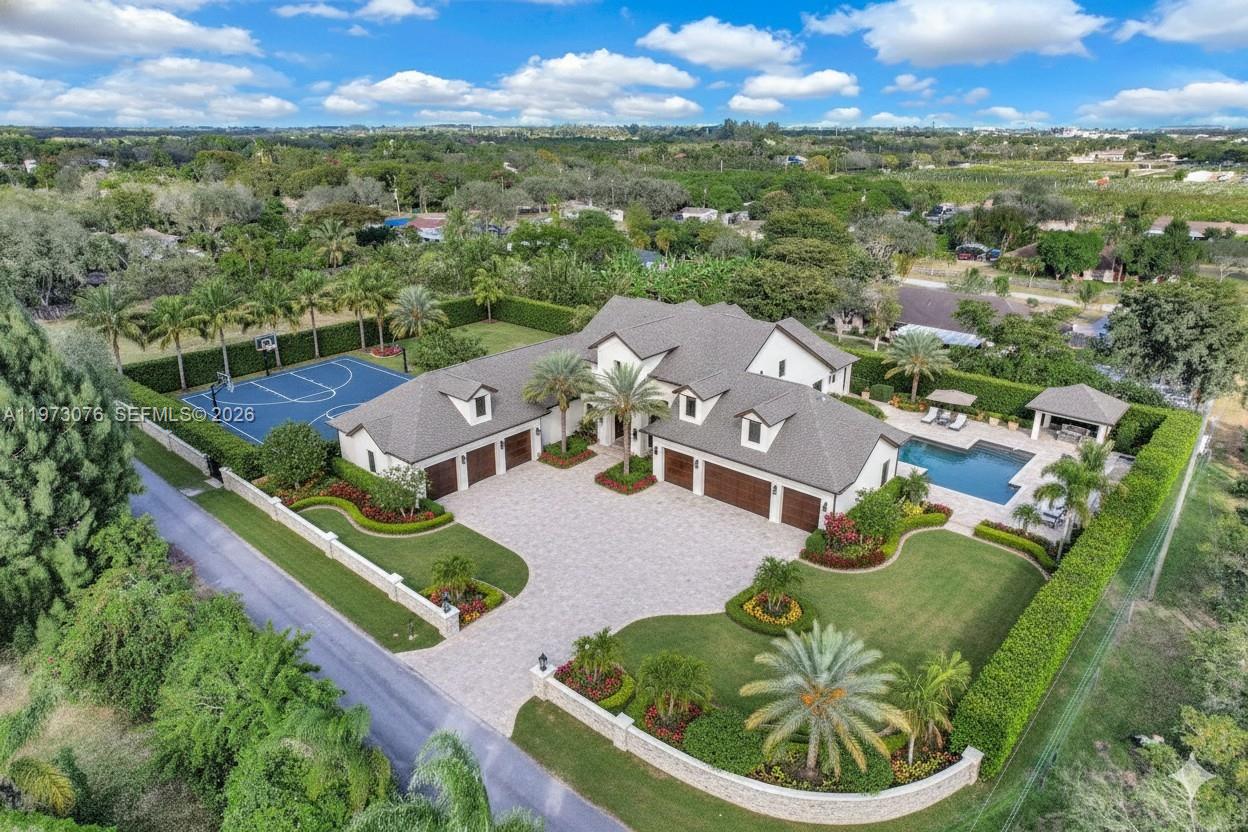 An aerial view of a large house with a basketball court, swimming pool, and driveway — 25730 SW 153 CT, Unincorporated Dade County FL 33032, UNINCORPORATED DADE COUNTY, FL