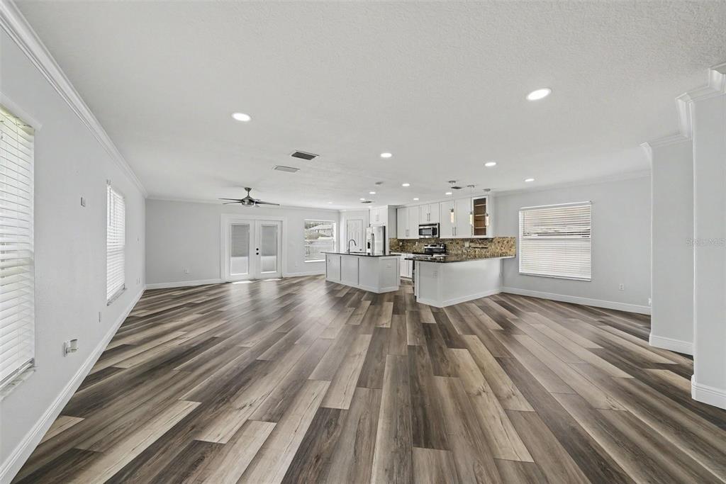 A two-story house with a white garage door, concrete driveway, and light-colored stucco exterior — 3327 THISTLEDOWN LANE, LAND O LAKES, FL